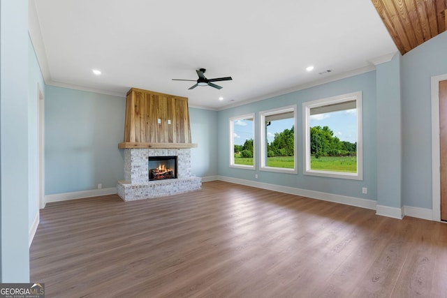 264 Community House Rd, Barnesville, GA 30204 - unfurnished living room featuring ceiling fan, ornamental molding, baseboards, a warm lit fireplace, and wood finished floors