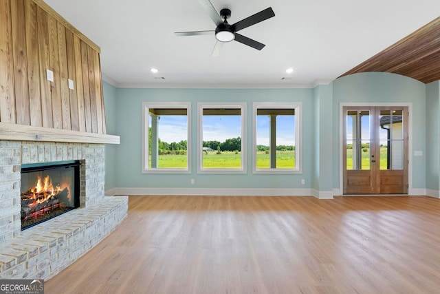 264 Community House Rd, Barnesville, GA 30204 - unfurnished living room with baseboards, a ceiling fan, ornamental molding, light wood-style flooring, and healthy amount of natural light