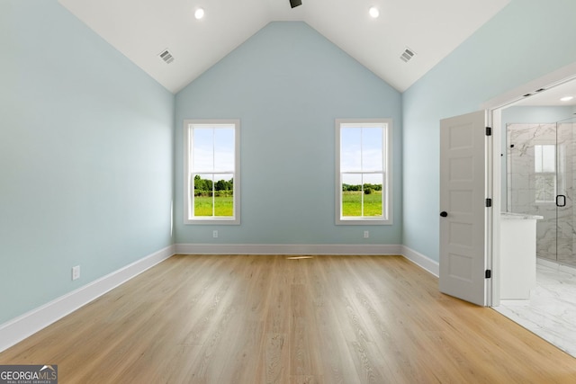 264 Community House Rd, Barnesville, GA 30204 - unfurnished bedroom with baseboards, recessed lighting, high vaulted ceiling, connected bathroom, and light wood-style floors