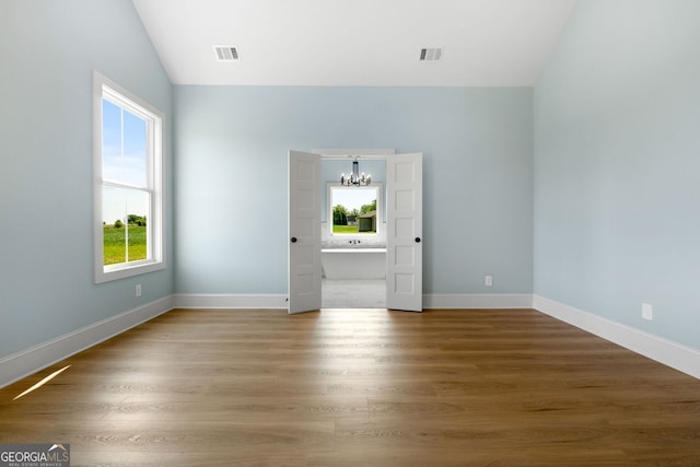 264 Community House Rd, Barnesville, GA 30204 - unfurnished living room with a chandelier, lofted ceiling, plenty of natural light, and wood finished floors
