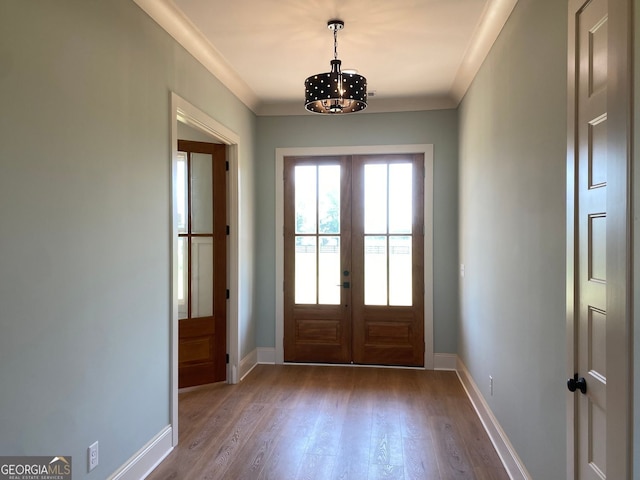 doorway featuring french doors, baseboards, dark wood-type flooring, and a chandelier