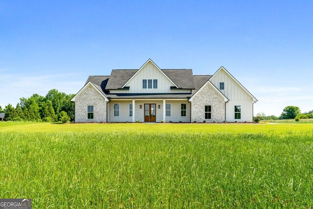 264 Community House Rd, Barnesville, GA 30204 - modern farmhouse featuring board and batten siding, a front yard, french doors, and roof with shingles