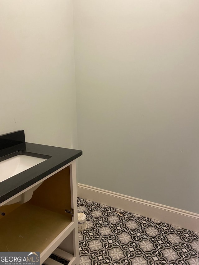 interior space with baseboards and a sink