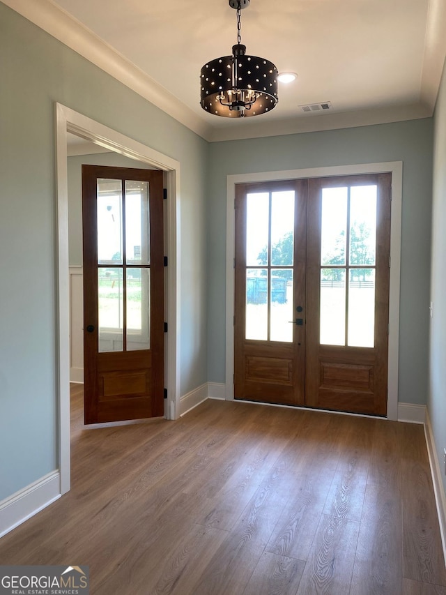 entryway featuring a wealth of natural light, french doors, wood finished floors, and visible vents