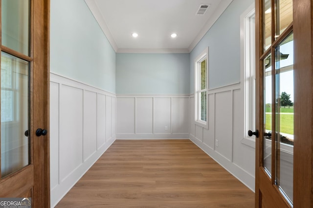 264 Community House Rd, Barnesville, GA 30204 - unfurnished room with a decorative wall, plenty of natural light, light wood-style flooring, ornamental molding, and wainscoting