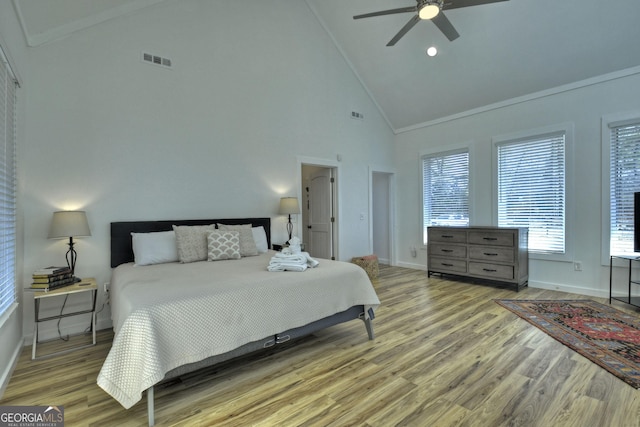 bedroom with baseboards, visible vents, high vaulted ceiling, and light wood-type flooring