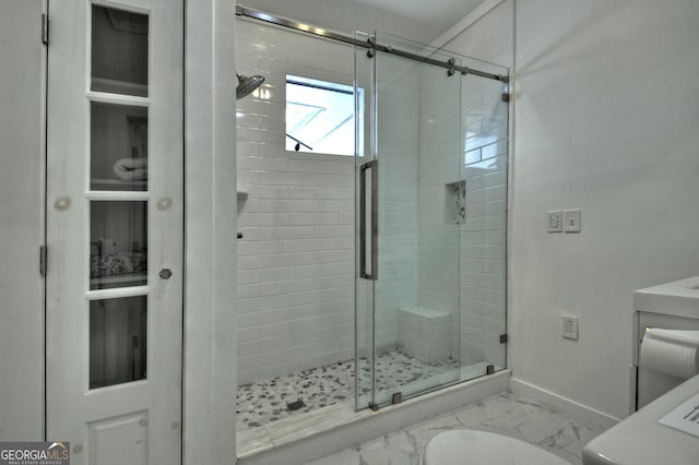 bathroom with baseboards, marble finish floor, and a stall shower