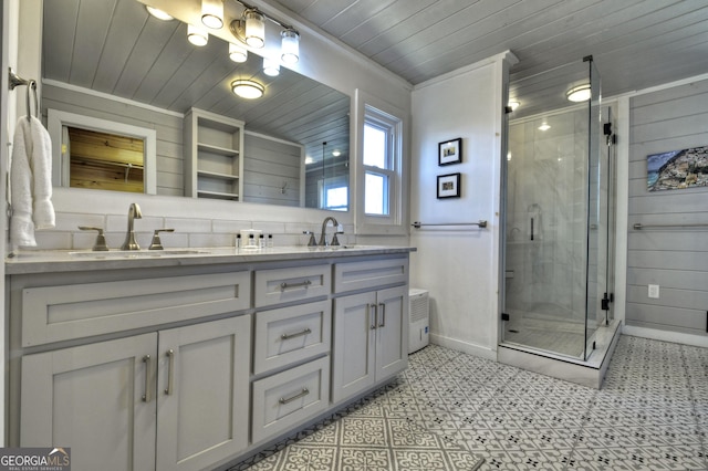 full bathroom with double vanity, a sink, wooden ceiling, and a shower stall