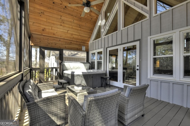 sunroom featuring french doors, a ceiling fan, an outdoor hangout area, and a hot tub