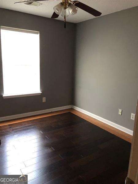 4528 Baker Grove Rd NW, Acworth, GA 30101 - spare room with ceiling fan and wood-type flooring