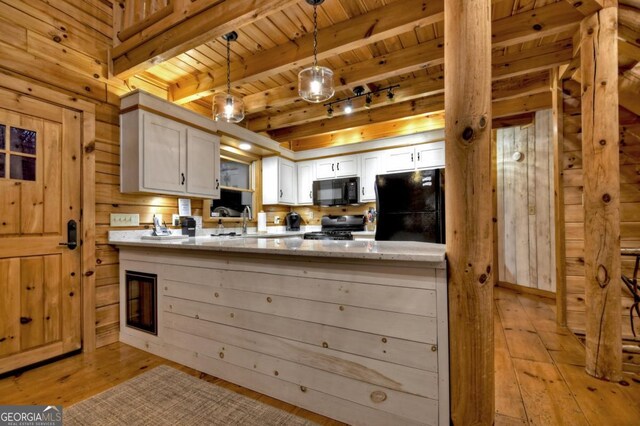 kitchen featuring wooden ceiling, light wood finished floors, a peninsula, beamed ceiling, and black appliances