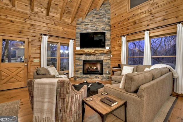 living area with a fireplace, wood finished floors, wood ceiling, and wood walls