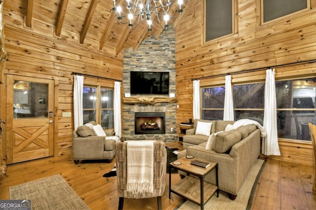 living area featuring wood walls, an inviting chandelier, wood ceiling, and hardwood / wood-style flooring