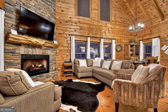 living room featuring hardwood / wood-style floors, wood walls, a chandelier, and wood ceiling