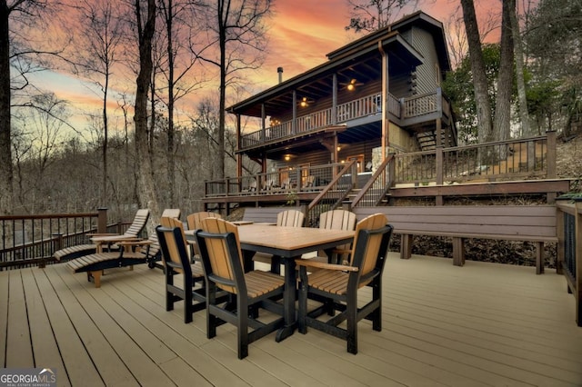 deck featuring stairs and outdoor dining space