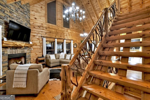 living room featuring wooden ceiling, stairway, wooden walls, hardwood / wood-style floors, and an inviting chandelier