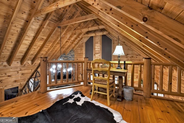 interior space featuring wooden ceiling, an upstairs landing, hardwood / wood-style flooring, and vaulted ceiling with beams
