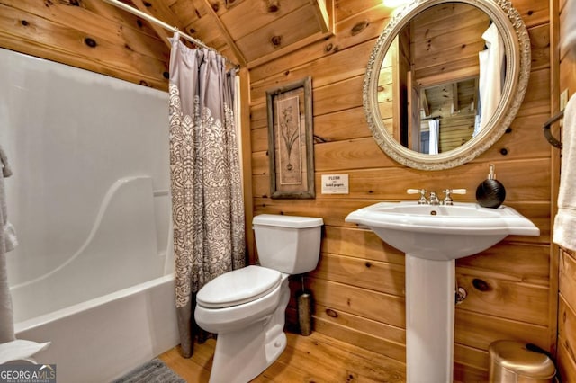 bathroom with toilet, wood ceiling, wooden walls, wood finished floors, and shower / bath combination with curtain