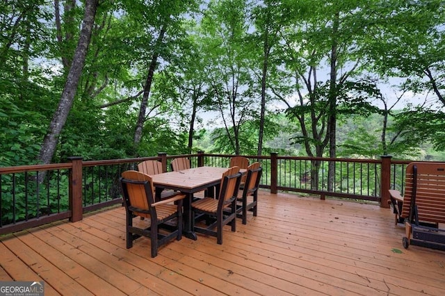 wooden terrace with outdoor dining area