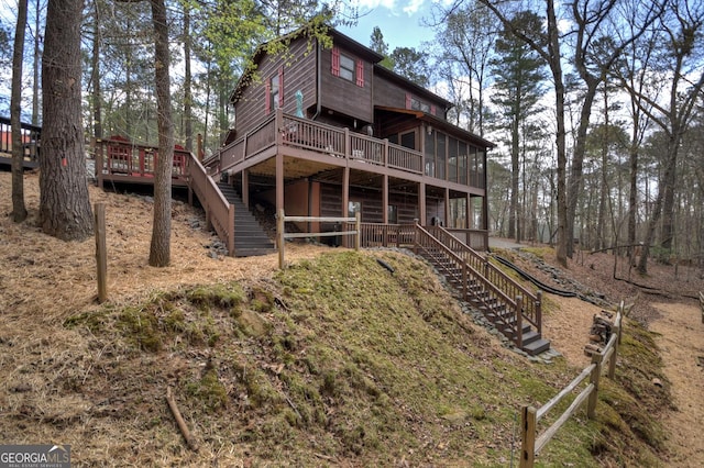 1301 Newport Dr, Ellijay, GA 30540 - back of property with stairway, a wooden deck, and a sunroom