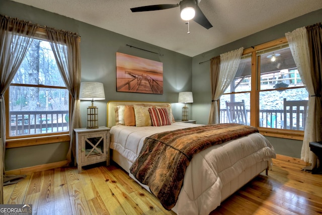 1301 Newport Dr, Ellijay, GA 30540 - bedroom featuring hardwood / wood-style floors, multiple windows, baseboards, and ceiling fan