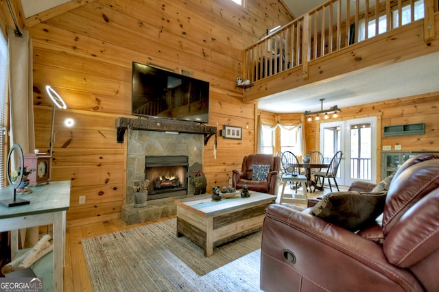 1301 Newport Dr, Ellijay, GA 30540 - living area with wood walls, hardwood / wood-style flooring, a fireplace, and a high ceiling
