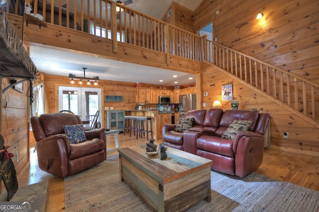 1301 Newport Dr, Ellijay, GA 30540 - living area with wood walls, light wood finished floors, a high ceiling, stairway, and recessed lighting