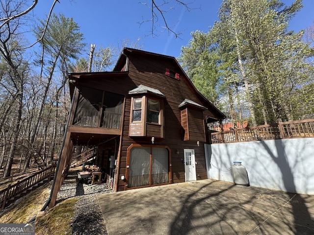 1301 Newport Dr, Ellijay, GA 30540 - view of side of property with a sunroom, an attached garage, and driveway