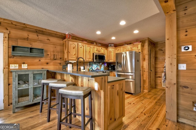 1301 Newport Dr, Ellijay, GA 30540 - kitchen with stainless steel appliances, a textured ceiling, a peninsula, light wood finished floors, and recessed lighting