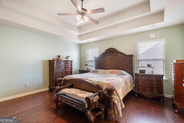 307 Montgomery Way, Woodstock, GA 30188 - bedroom featuring a tray ceiling, dark wood-style floors, baseboards, and a ceiling fan