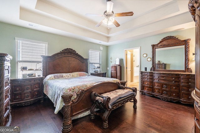 307 Montgomery Way, Woodstock, GA 30188 - bedroom featuring a tray ceiling, wood finished floors, multiple windows, and ensuite bathroom