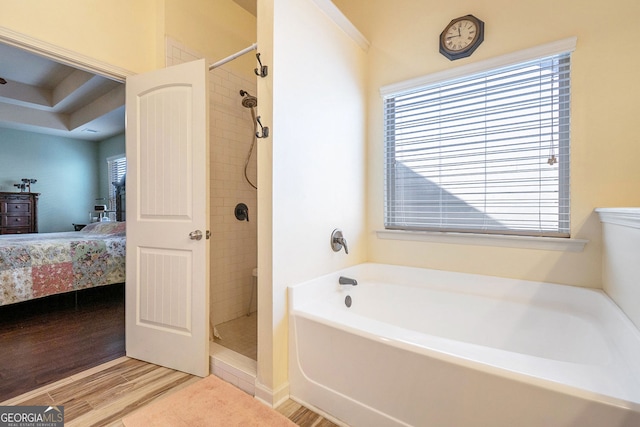 307 Montgomery Way, Woodstock, GA 30188 - bathroom featuring connected bathroom, a stall shower, wood finished floors, and a garden tub