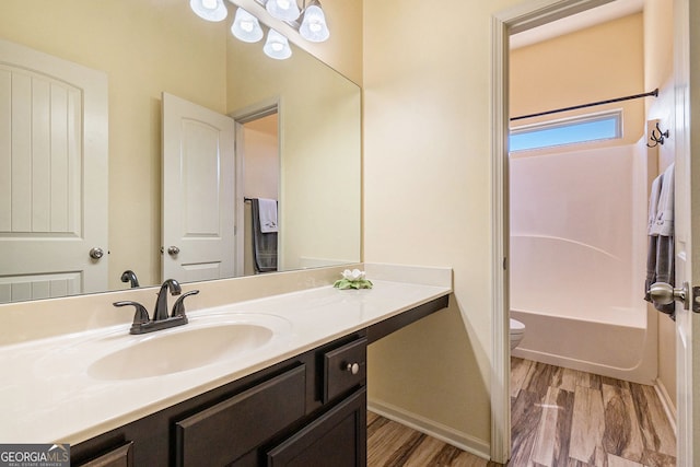 307 Montgomery Way, Woodstock, GA 30188 - full bath with toilet, vanity, wood finished floors, baseboards, and shower / washtub combination
