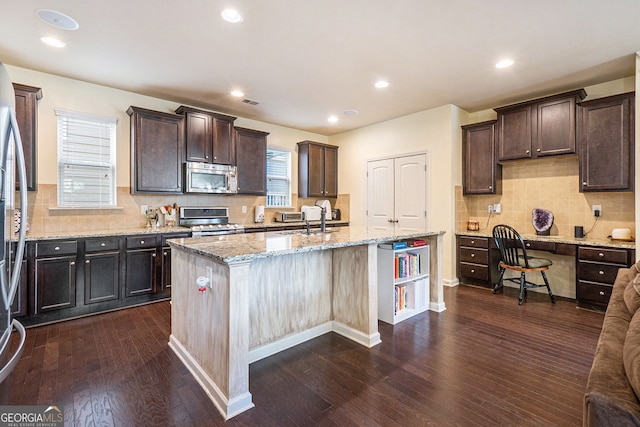 307 Montgomery Way, Woodstock, GA 30188 - kitchen with stainless steel appliances, dark wood-type flooring, dark brown cabinetry, a sink, and recessed lighting