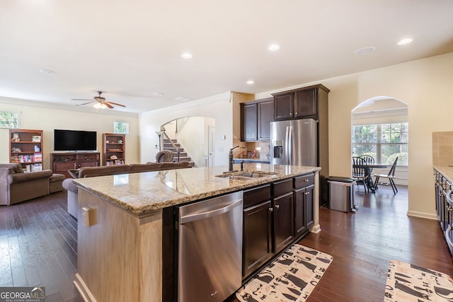 307 Montgomery Way, Woodstock, GA 30188 - kitchen with arched walkways, appliances with stainless steel finishes, a sink, ceiling fan, and a kitchen island with sink