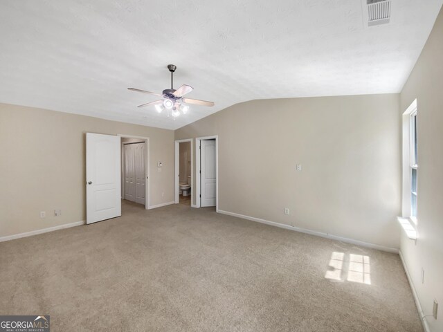 1005 Magnolia Gardens Walk, Mcdonough, GA 30253 - unfurnished bedroom with baseboards, visible vents, vaulted ceiling, and light carpet