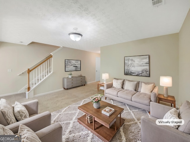 1005 Magnolia Gardens Walk, Mcdonough, GA 30253 - living room with stairway, light carpet, a textured ceiling, baseboards, and visible vents