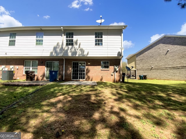 1005 Magnolia Gardens Walk, Mcdonough, GA 30253 - back of house with central AC unit, a lawn, a patio area, and brick siding