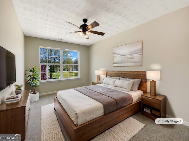 1005 Magnolia Gardens Walk, Mcdonough, GA 30253 - carpeted bedroom featuring baseboards, visible vents, a ceiling fan, and a textured ceiling
