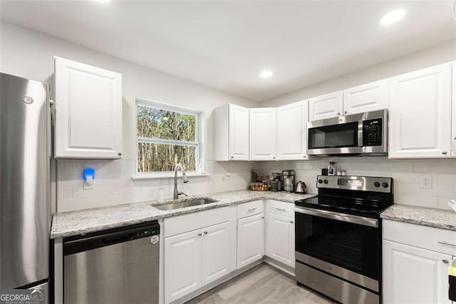 2374 Buchanan Hwy, Dallas, GA 30157 - kitchen with white cabinetry, a sink, stainless steel appliances, and tasteful backsplash
