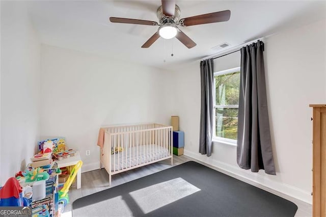 2374 Buchanan Hwy, Dallas, GA 30157 - unfurnished bedroom with wood finished floors, baseboards, a nursery area, and visible vents