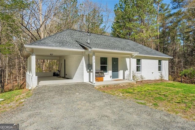 2374 Buchanan Hwy, Dallas, GA 30157 - single story home with driveway, an attached carport, brick siding, a shingled roof, and a porch
