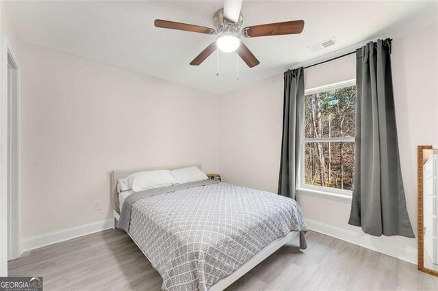 2374 Buchanan Hwy, Dallas, GA 30157 - bedroom with baseboards, wood finished floors, and multiple windows