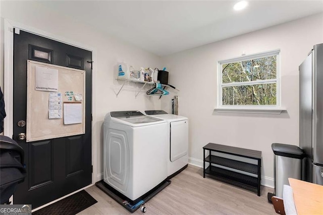2374 Buchanan Hwy, Dallas, GA 30157 - laundry room featuring light wood finished floors, washer and clothes dryer, laundry area, and baseboards