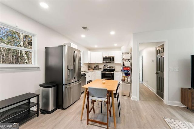 2374 Buchanan Hwy, Dallas, GA 30157 - kitchen featuring white cabinetry, light countertops, light wood finished floors, visible vents, and appliances with stainless steel finishes