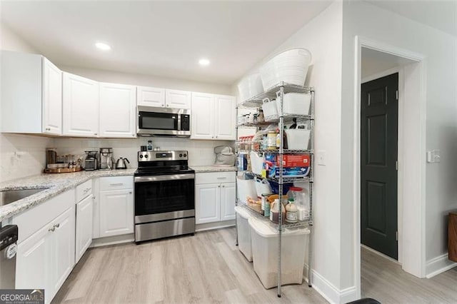 2374 Buchanan Hwy, Dallas, GA 30157 - kitchen featuring white cabinetry, light wood-style floors, backsplash, and stainless steel appliances