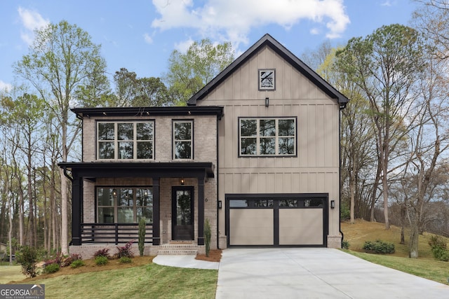 modern farmhouse with driveway, an attached garage, brick siding, a front lawn, and a porch