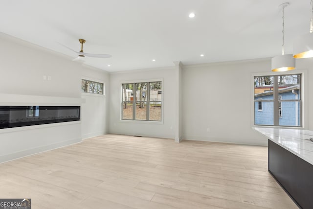 unfurnished living room with baseboards, recessed lighting, a ceiling fan, light wood-style floors, and a glass covered fireplace