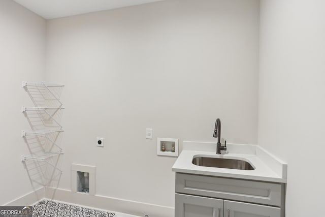 laundry area with hookup for a washing machine, baseboards, a sink, electric dryer hookup, and cabinet space