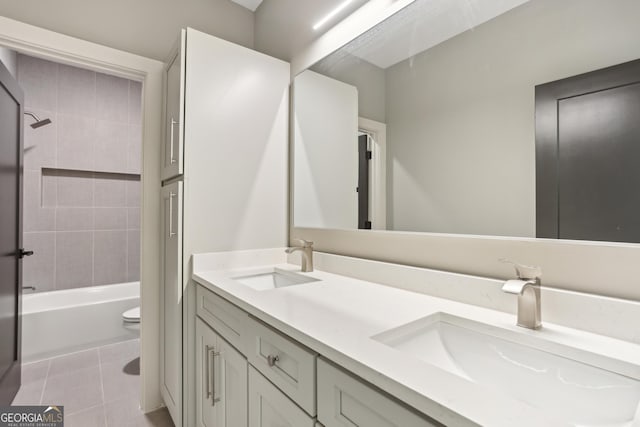 full bath featuring tile patterned flooring, a sink, double vanity, and tub / shower combination
